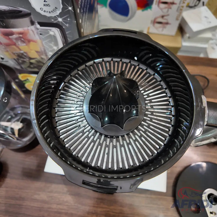 A black and silver citrus juicer with a ribbed reamer and strainer.