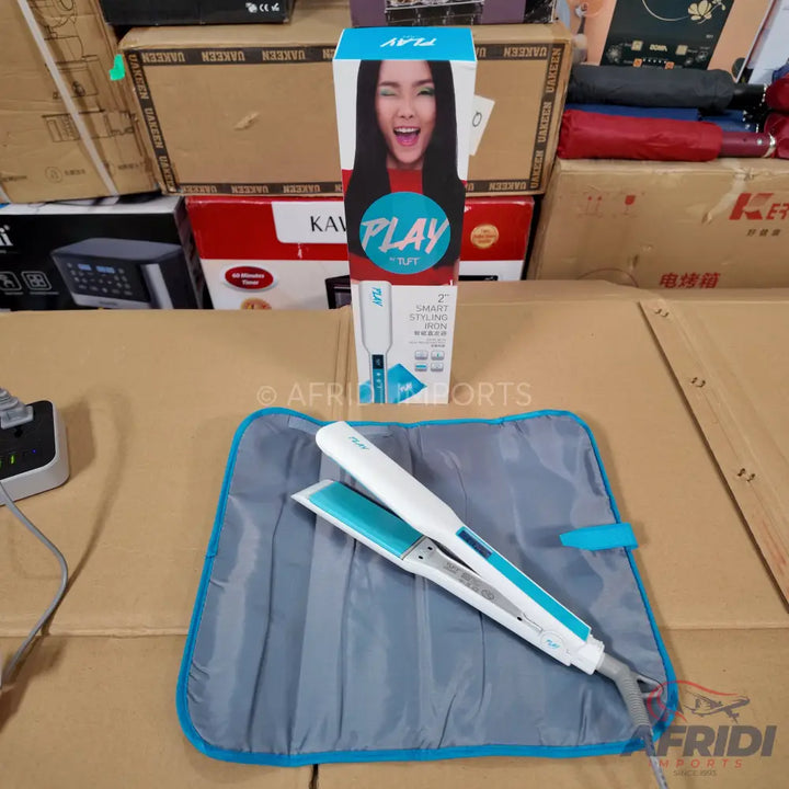 White and teal hair straightener with a matching heat-resistant mat.