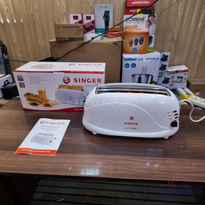 A white two-slice toaster with a brown box and instruction manual.