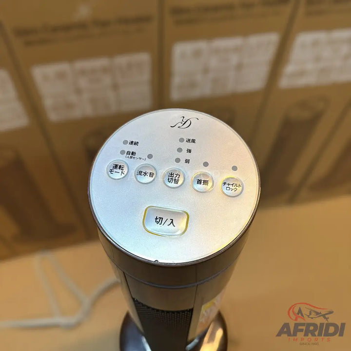 A white and gray tower fan with a circular control panel.