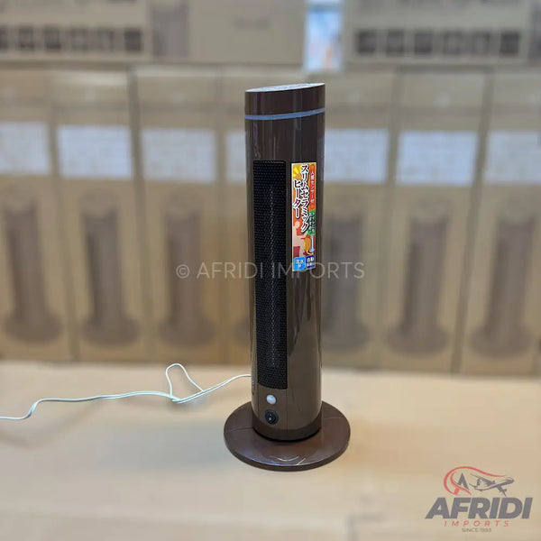 A tall, dark brown, cylindrical tower fan with a flat round base and a power cord.