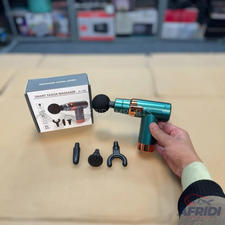 A teal and rose gold smart fascia massager with multiple interchangeable heads.