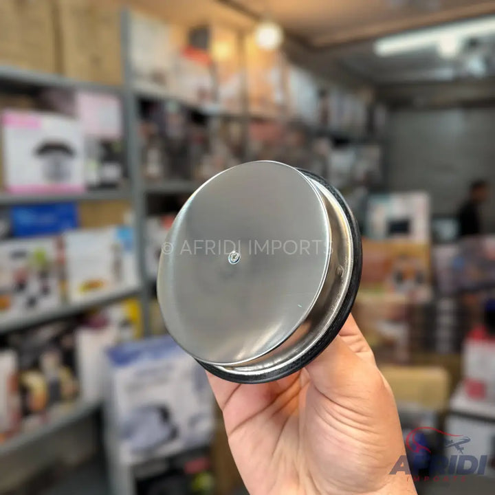 A circular, silver-colored, metallic kitchen sink drain stopper.