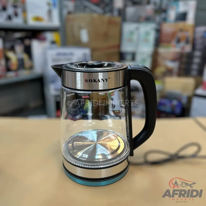 A clear glass electric kettle with a black handle and a blue base.