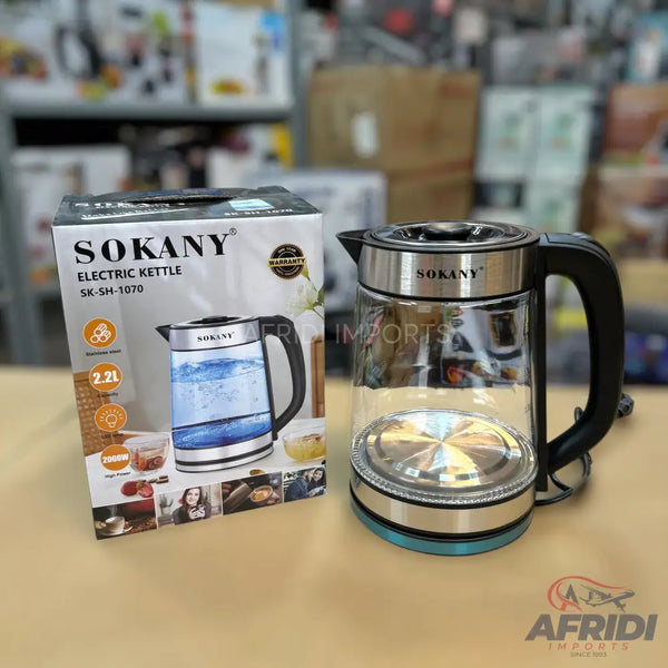 A clear glass electric kettle with a black handle and a silver base.