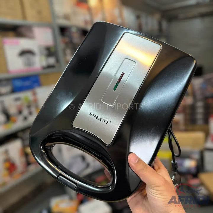 Black sandwich maker with a silver top panel and indicator lights.