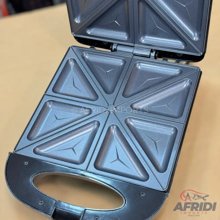 Open 8-slice electric sandwich maker with non-stick triangular cooking plates.