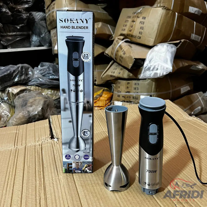 A stainless steel hand blender with a black and gray grip, featuring two control buttons and a 700W motor.