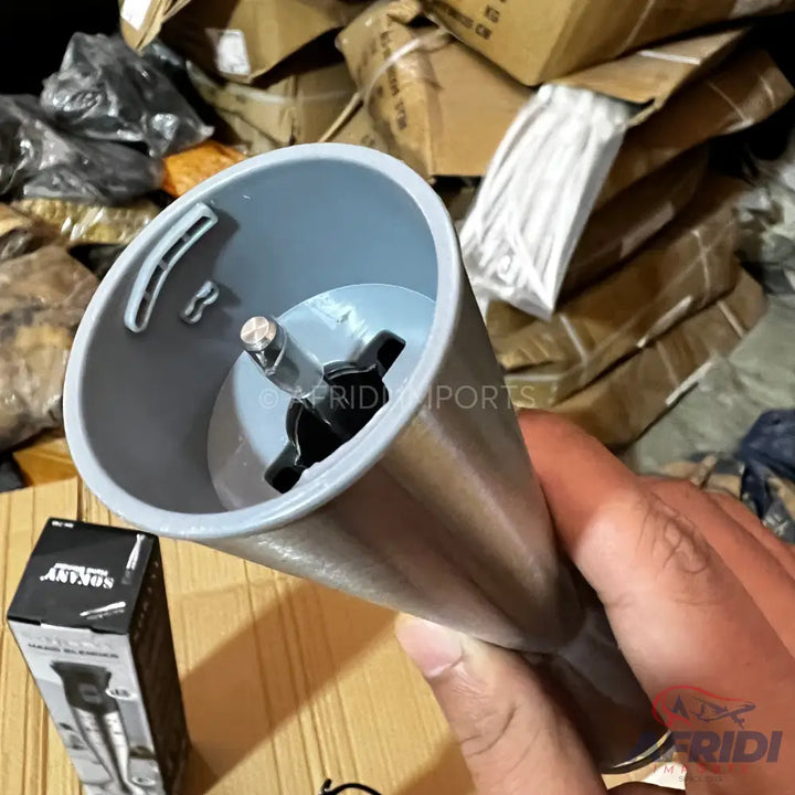 A handheld immersion blender with a gray plastic blending shaft and black blades.
