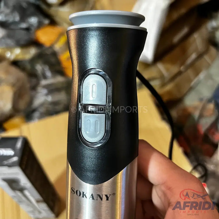 Black and silver handheld immersion blender with two grey control buttons.