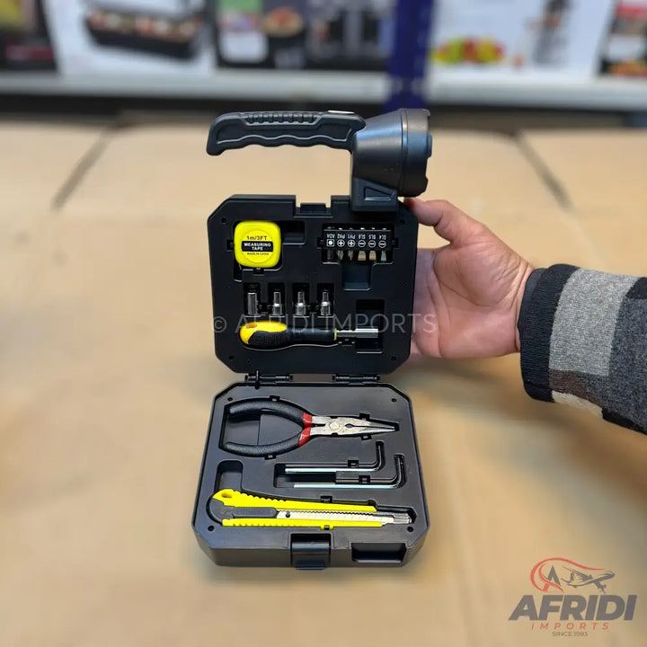 A black tool kit with a built-in flashlight, containing various hand tools like a tape measure, screwdriver bits, pliers, Allen wrenches, and utility knives.
