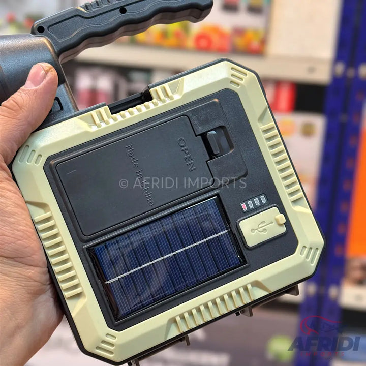 A rugged, portable solar-powered flashlight with a USB charging port and battery indicator.