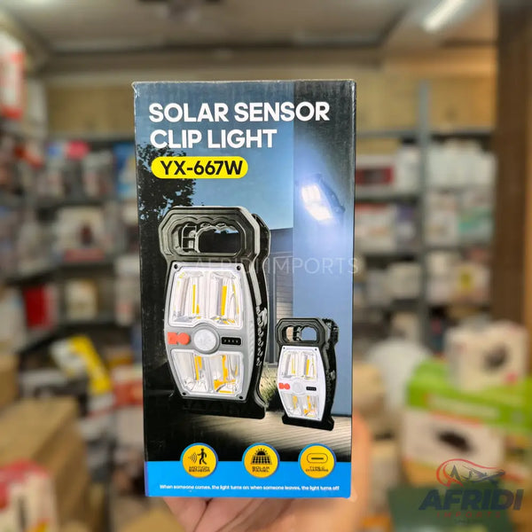 A solar sensor clip light with multiple LED panels and a built-in handle.