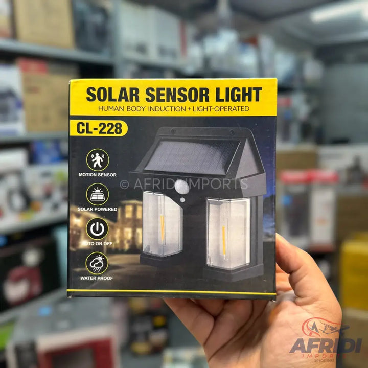 A black solar sensor light with two lamp heads, motion detection, and a waterproof design.
