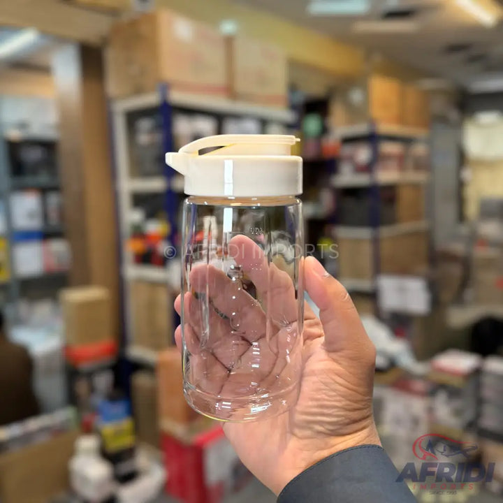 Clear glass water bottle with a cream-colored flip-top lid.