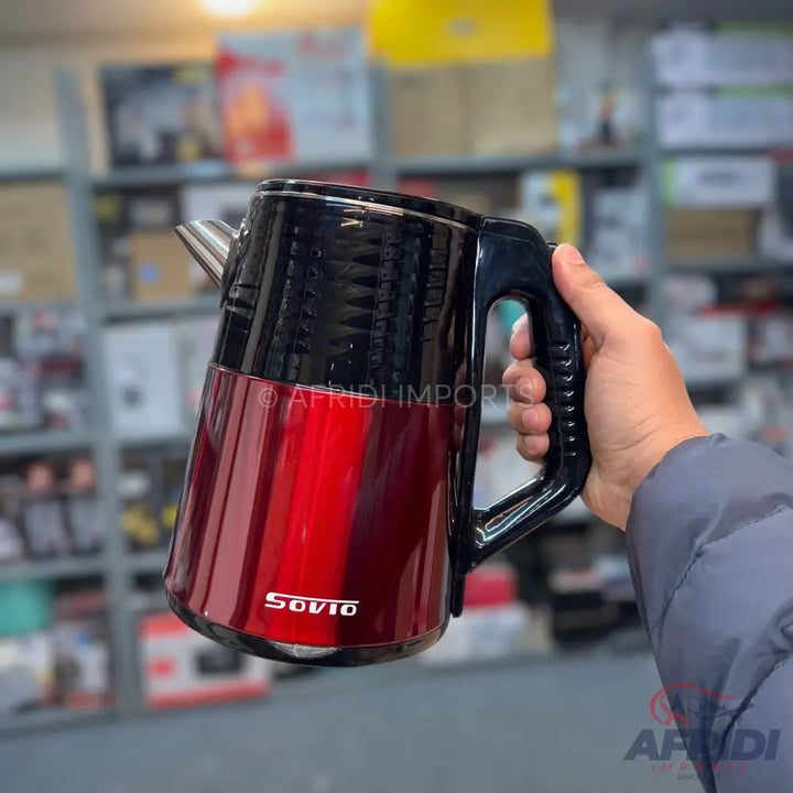 Red and black electric kettle with a black handle.