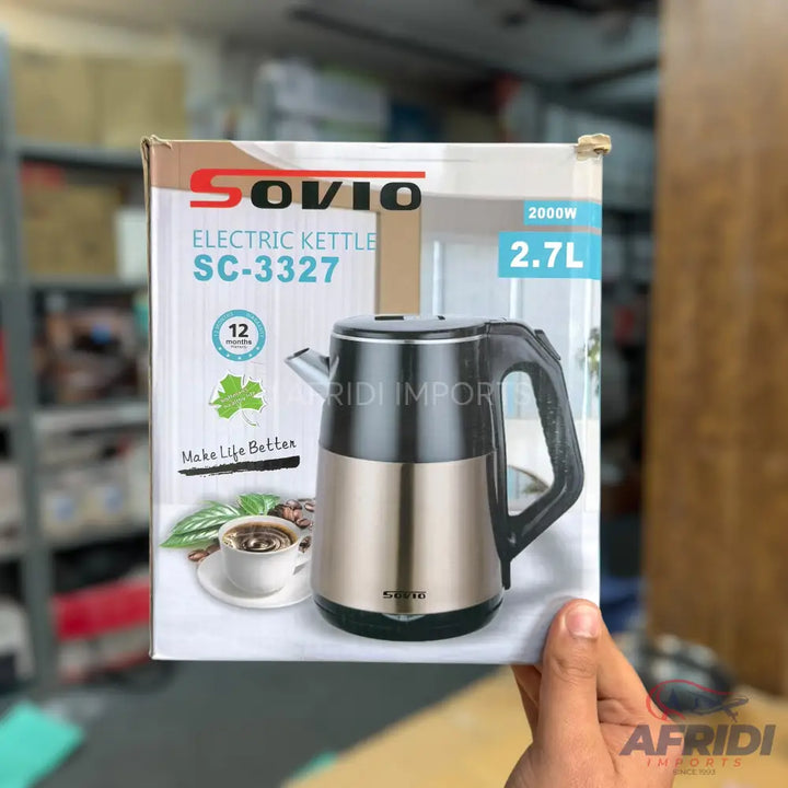A stainless steel electric kettle with a black handle.