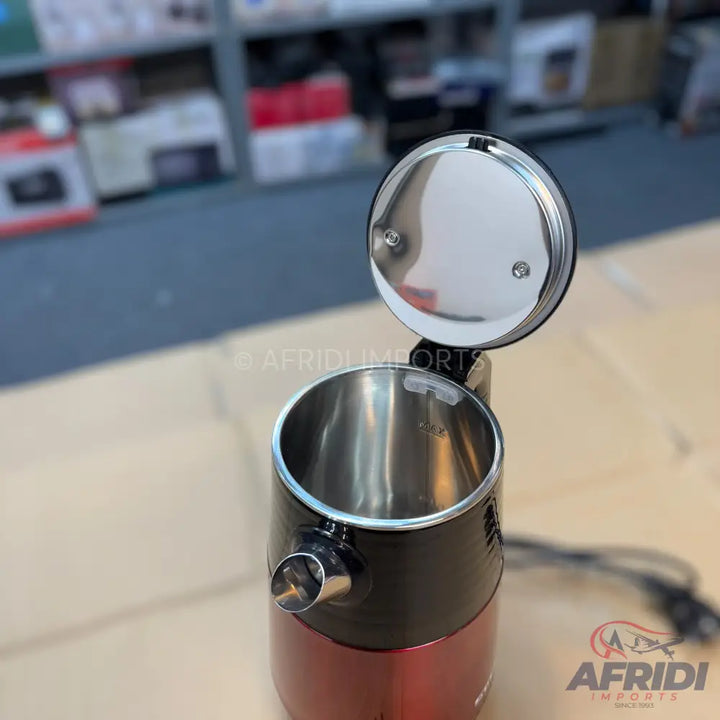 Red and black electric kettle with an open, silver-colored lid and a stainless steel interior.