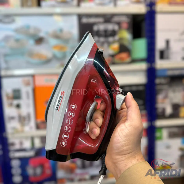 A red and white steam iron with a temperature control dial.