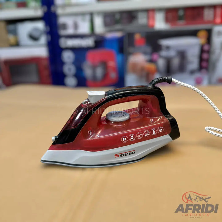 A red and black steam iron with a white soleplate.