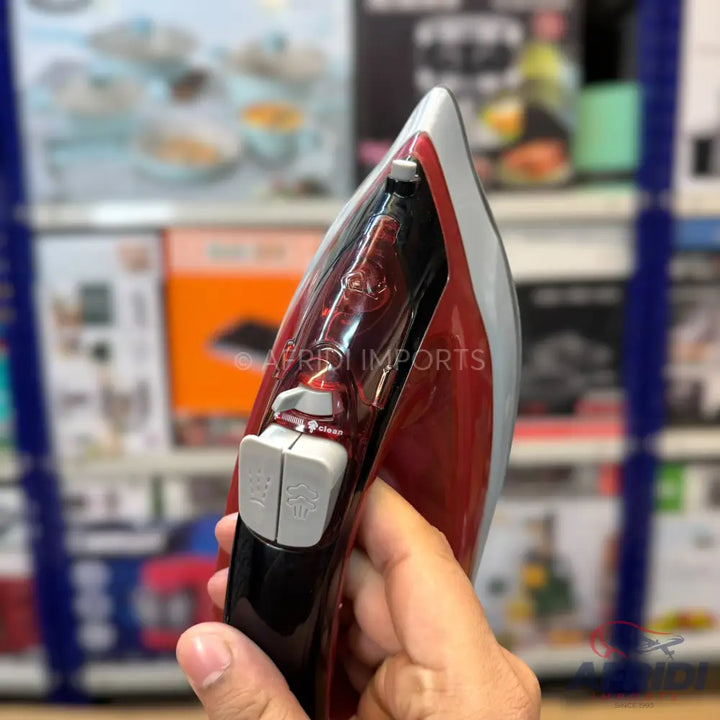 Red and black steam iron with a water tank and spray/steam buttons.