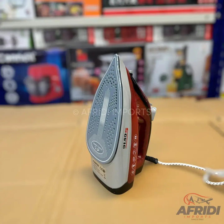 Red and silver electric steam iron with a textured soleplate.