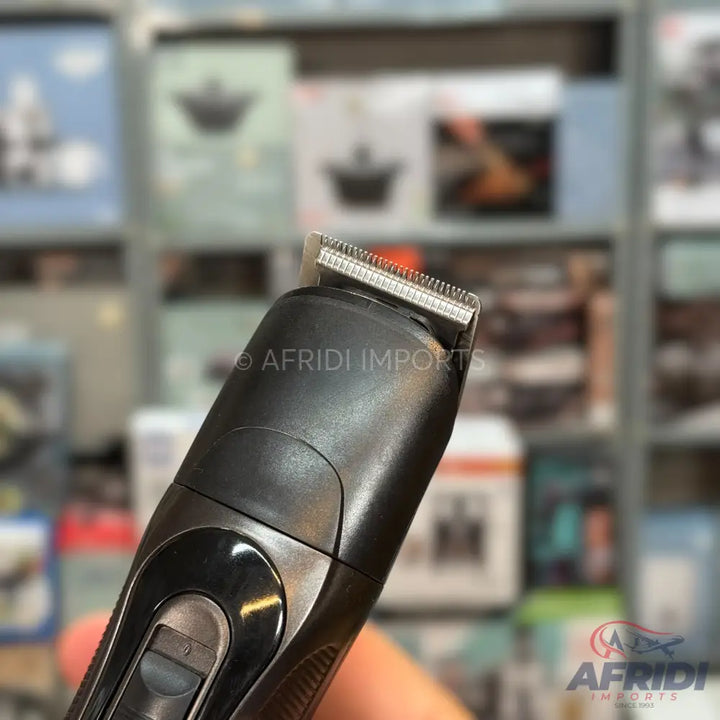 Black electric hair trimmer with a metal blade.