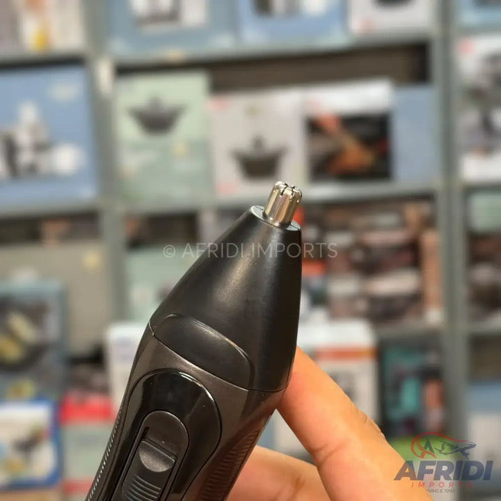 A black and grey electric nose and ear hair trimmer with a cylindrical metal cutting head.