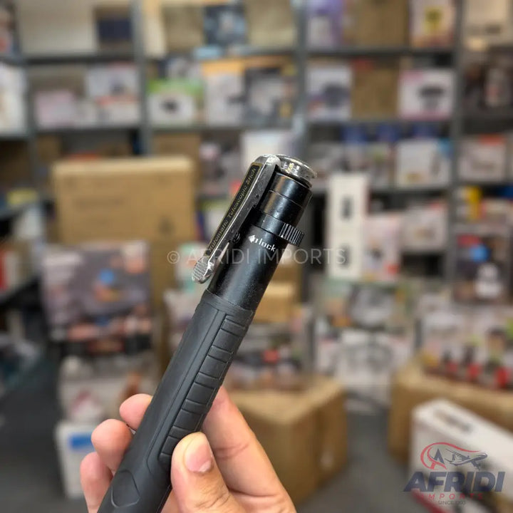 Black retractable baton with a silver clip.