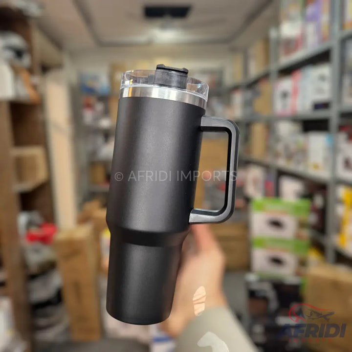 Black insulated travel mug with a handle and clear lid.