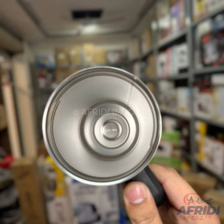 Stainless steel thermal flask with a concentric ring design on the base.