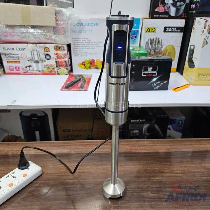 Stainless steel immersion blender with a black handle and blue indicator light.