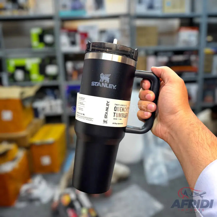 A black Stanley Quencher tumbler with a handle.