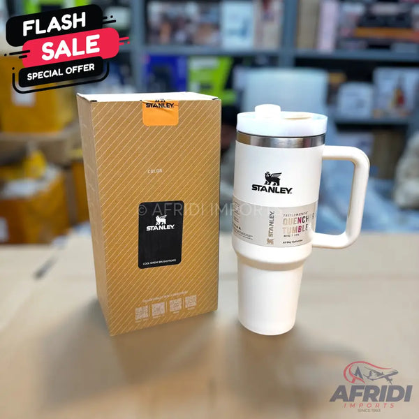 White Stanley Quencher H2.0 FlowState Tumbler with handle and its brown packaging box.