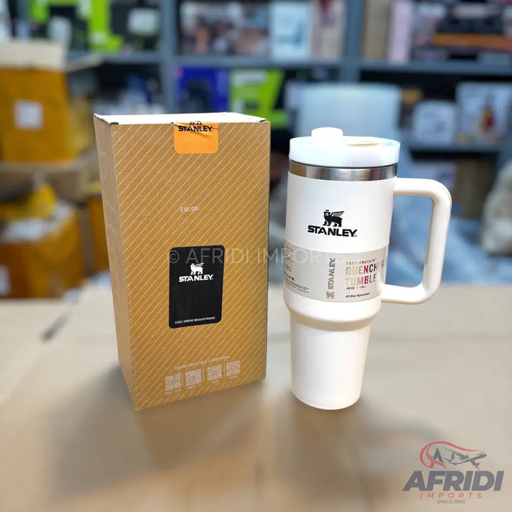 White Stanley Quencher H2.0 FlowState Tumbler with handle and its brown packaging box.
