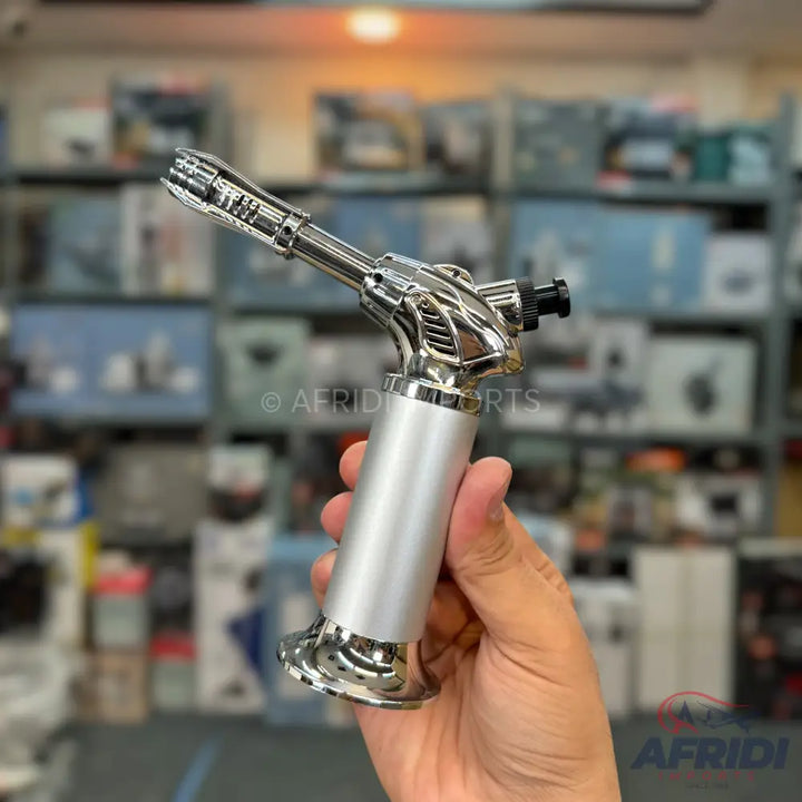 Silver and black handheld butane torch.