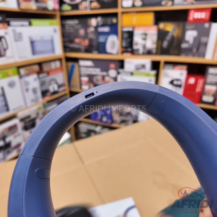 Blue over-ear wireless headphones with a USB-C charging port.