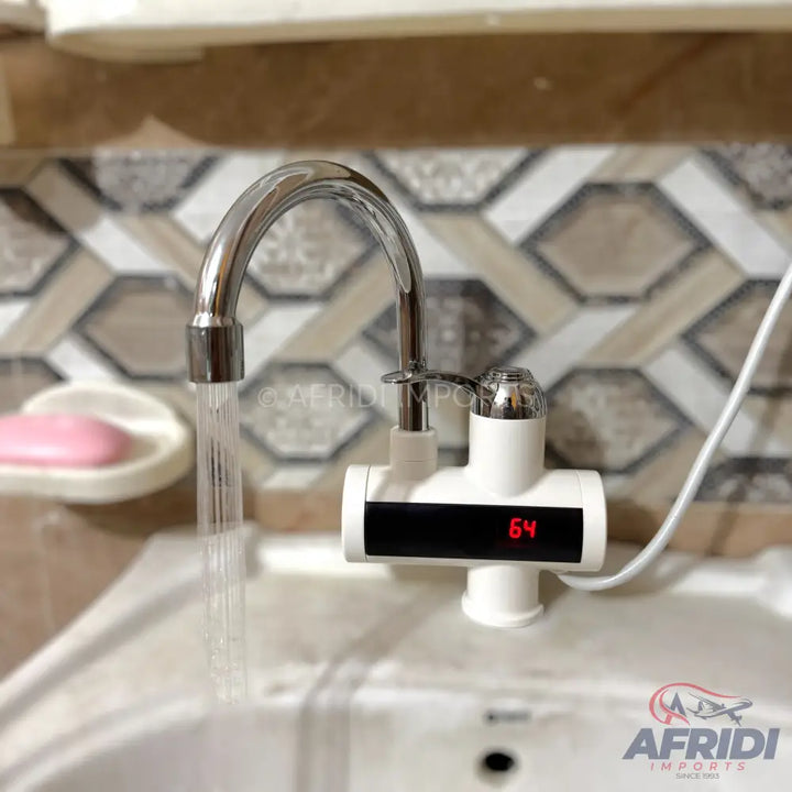 Chrome faucet with an integrated white electric water heater unit and digital temperature display.