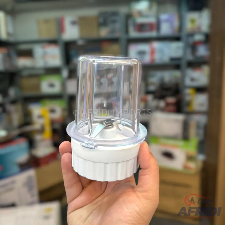 White blender jar with a clear cup and a two-blade attachment.