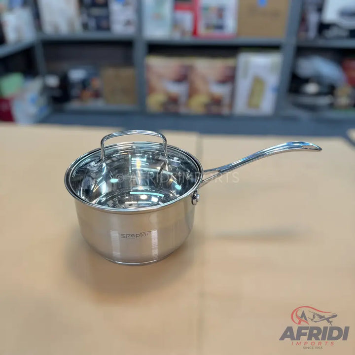 Stainless steel saucepan with a clear glass lid and ergonomic handle.