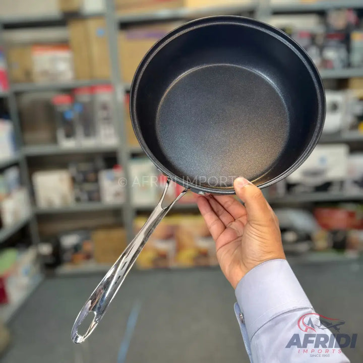 Black non-stick saucepan with a long, polished metal handle.