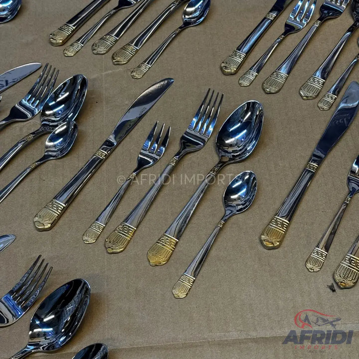 A collection of shiny silver and gold-accented flatware.