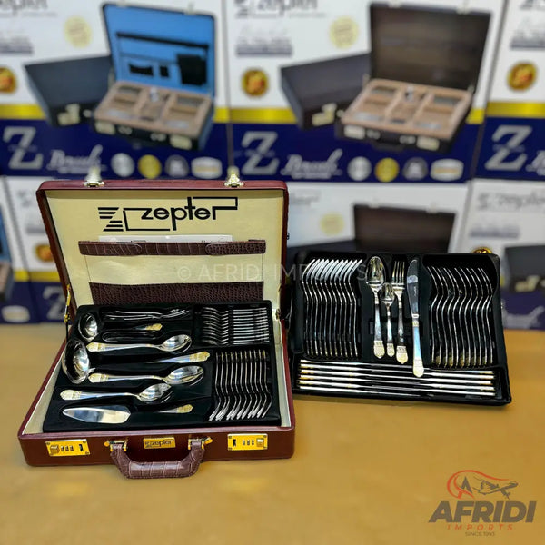A Zepter branded cutlery set in a maroon briefcase, containing various spoons, forks, and knives.