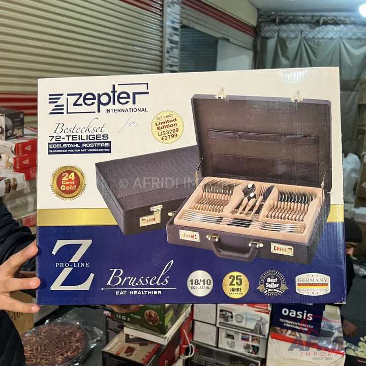 A Zepter International 72-piece cutlery set in a dark brown carrying case, with a gold-colored finish on the utensils.