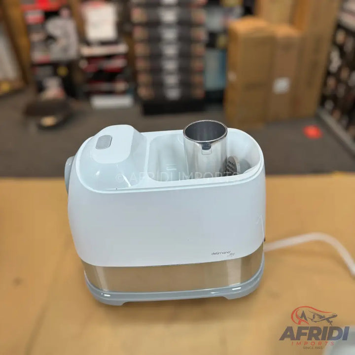 White and silver electric baby bottle warmer and sterilizer with two compartments.