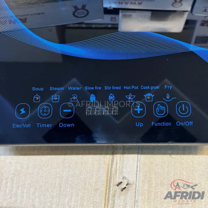 Black induction cooktop with touch controls for various cooking functions.