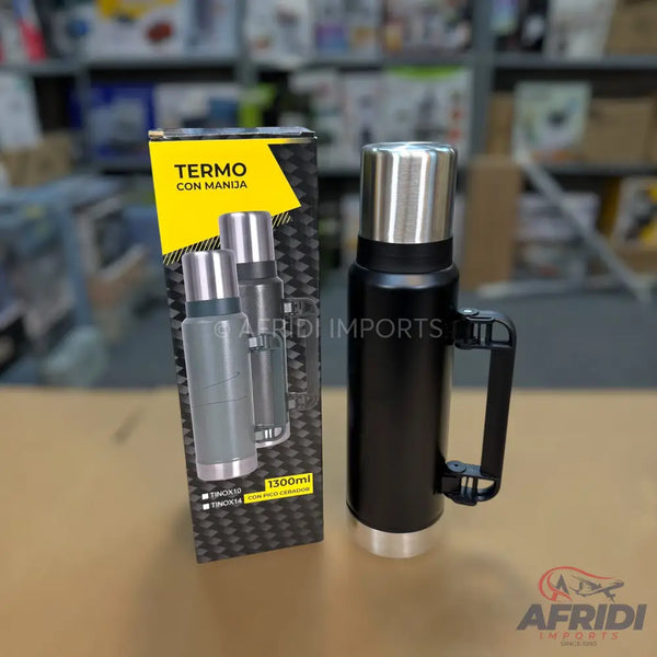 Black thermos with a handle and a stainless steel cap, packaged in a box displaying a grey version of the same thermos.