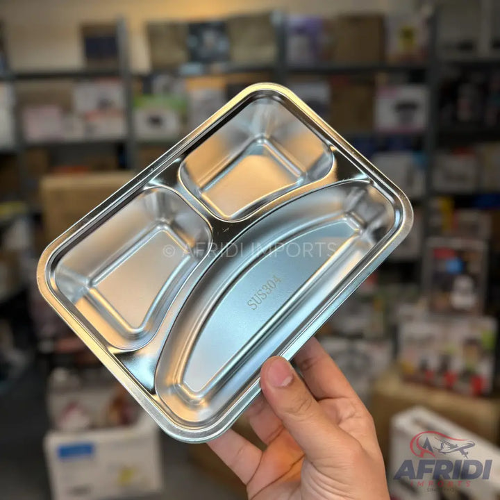 A stainless steel three-compartment food tray.