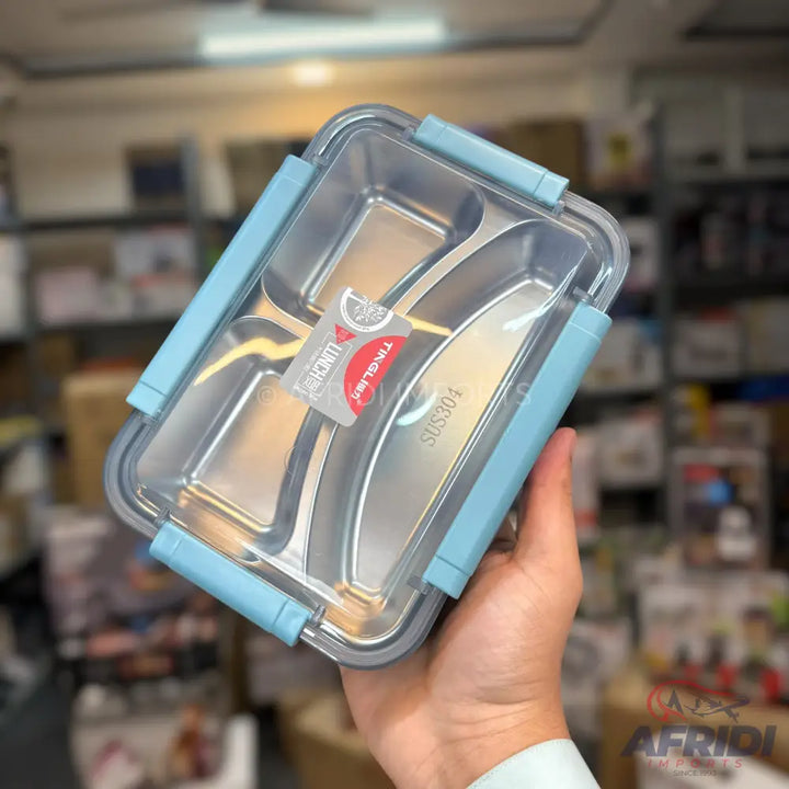 A light blue, clear-lidded lunchbox with a stainless steel, three-compartment insert.