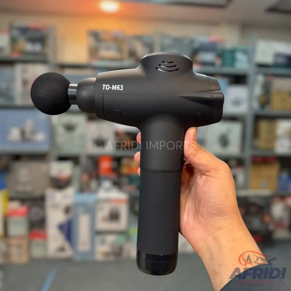 Black percussive massage gun with a spherical attachment.